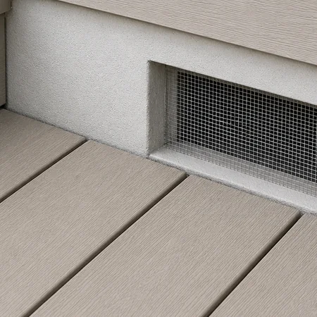 Close-up photograph of wall base on a house